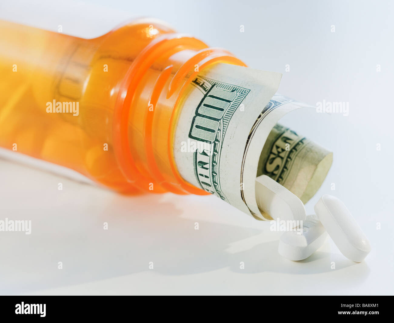 Money in prescription bottle Stock Photo