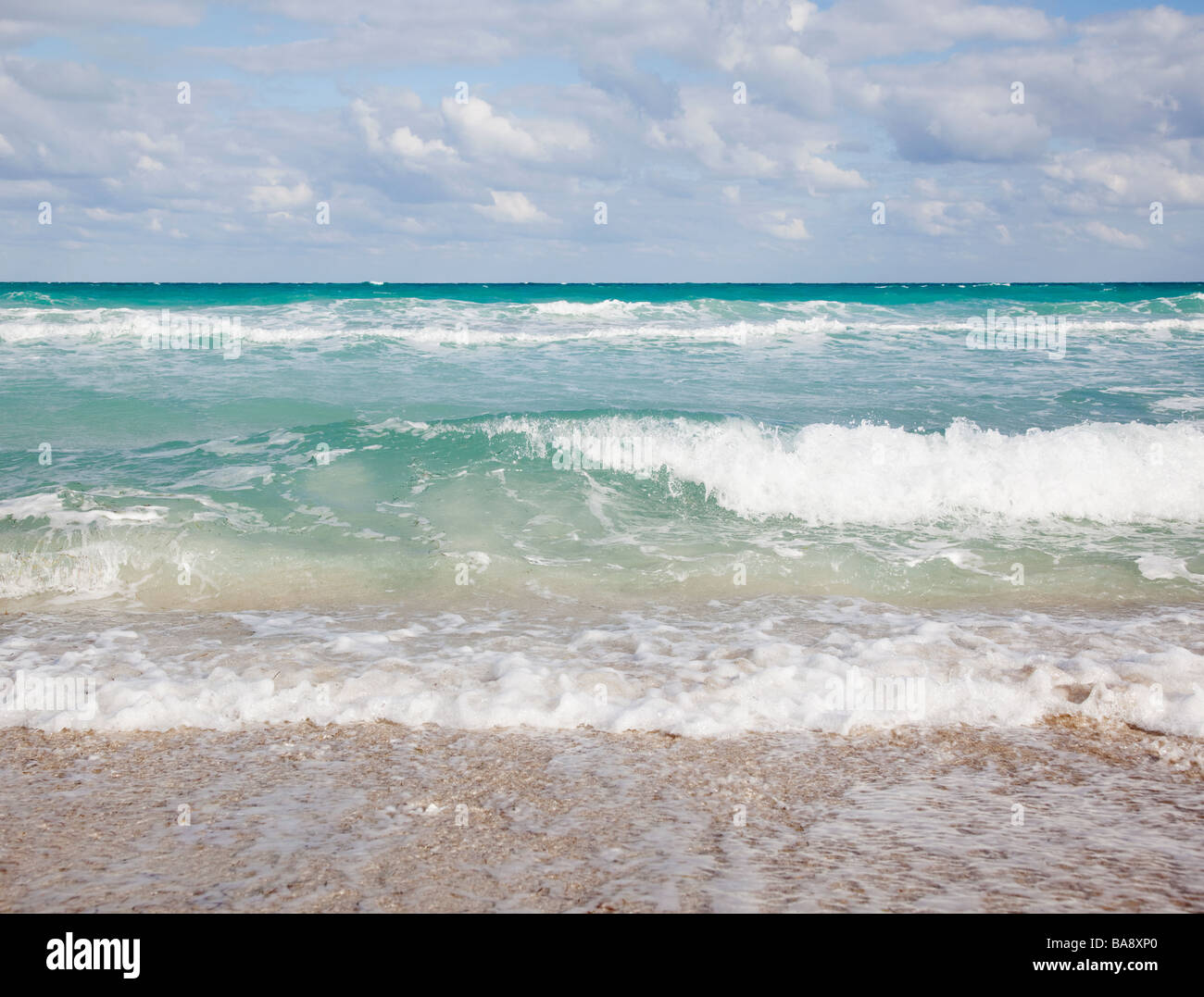 Waves crashing on beach Stock Photo - Alamy