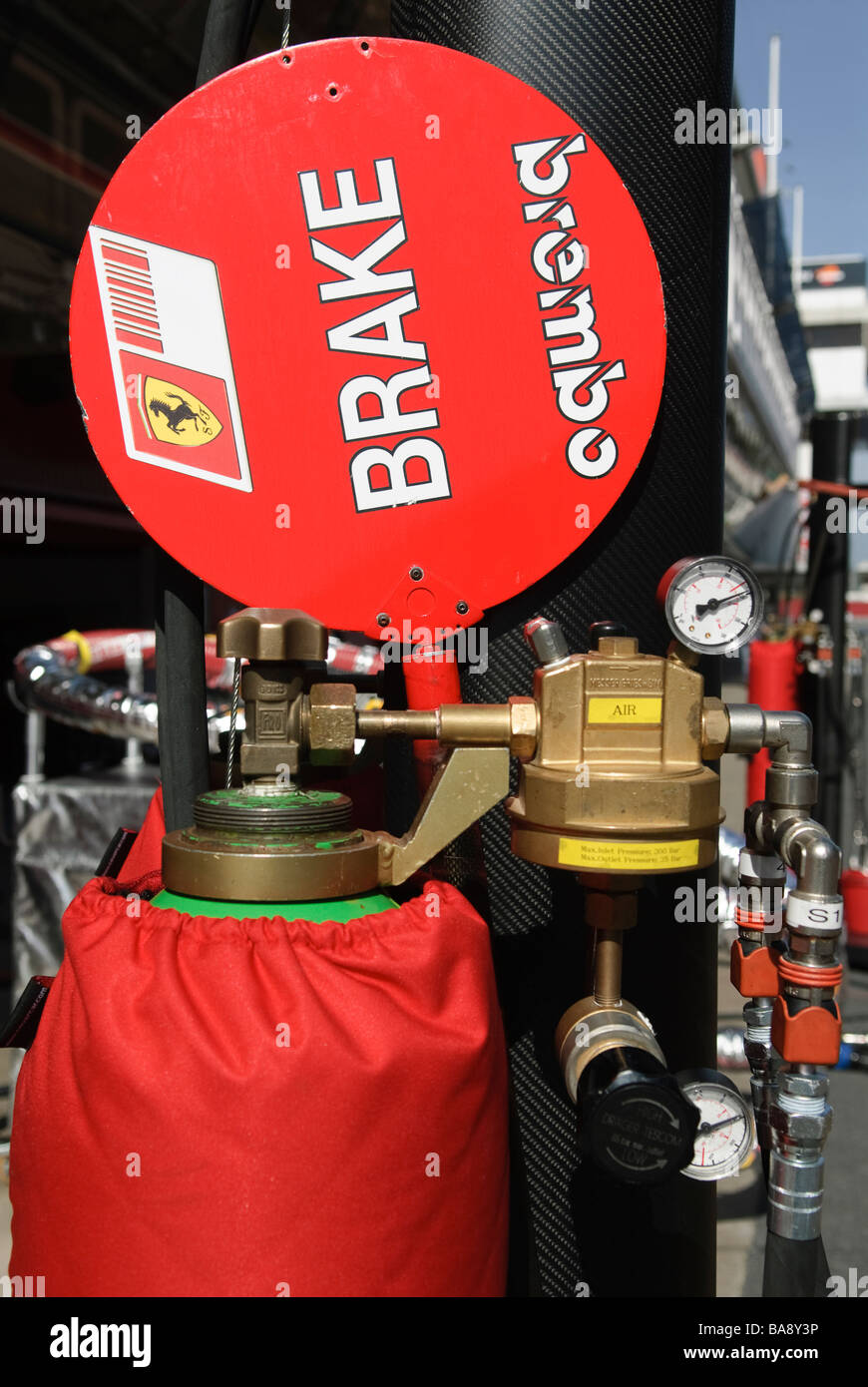 pressured gas bottle and lollypop in Ferrari Box at racetrack at Formula One testing sessions Stock Photo