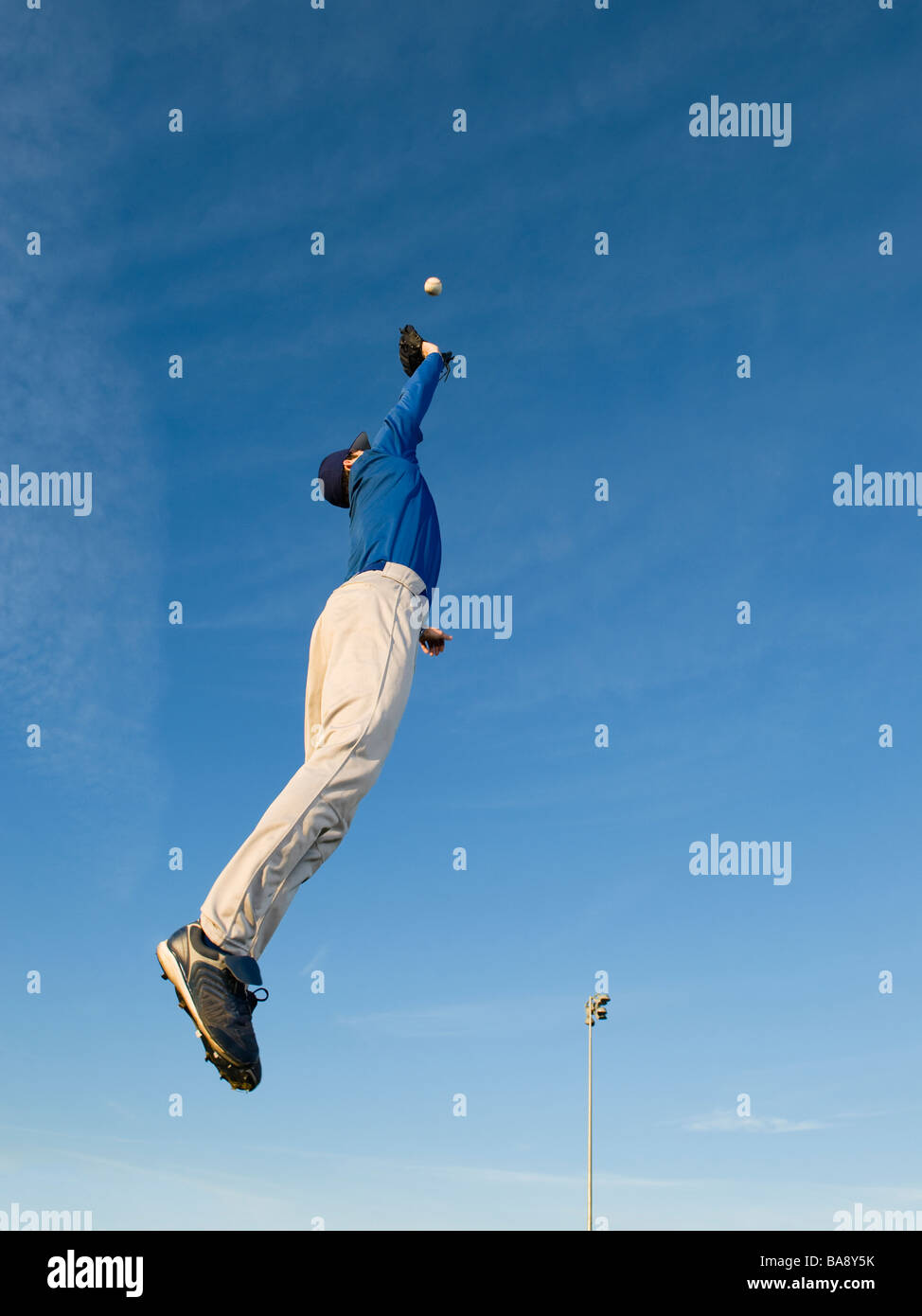 Baseball player catching ball Stock Photo - Alamy