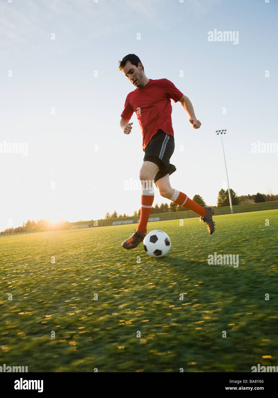 Soccer player dribbling ball Stock Photo Alamy
