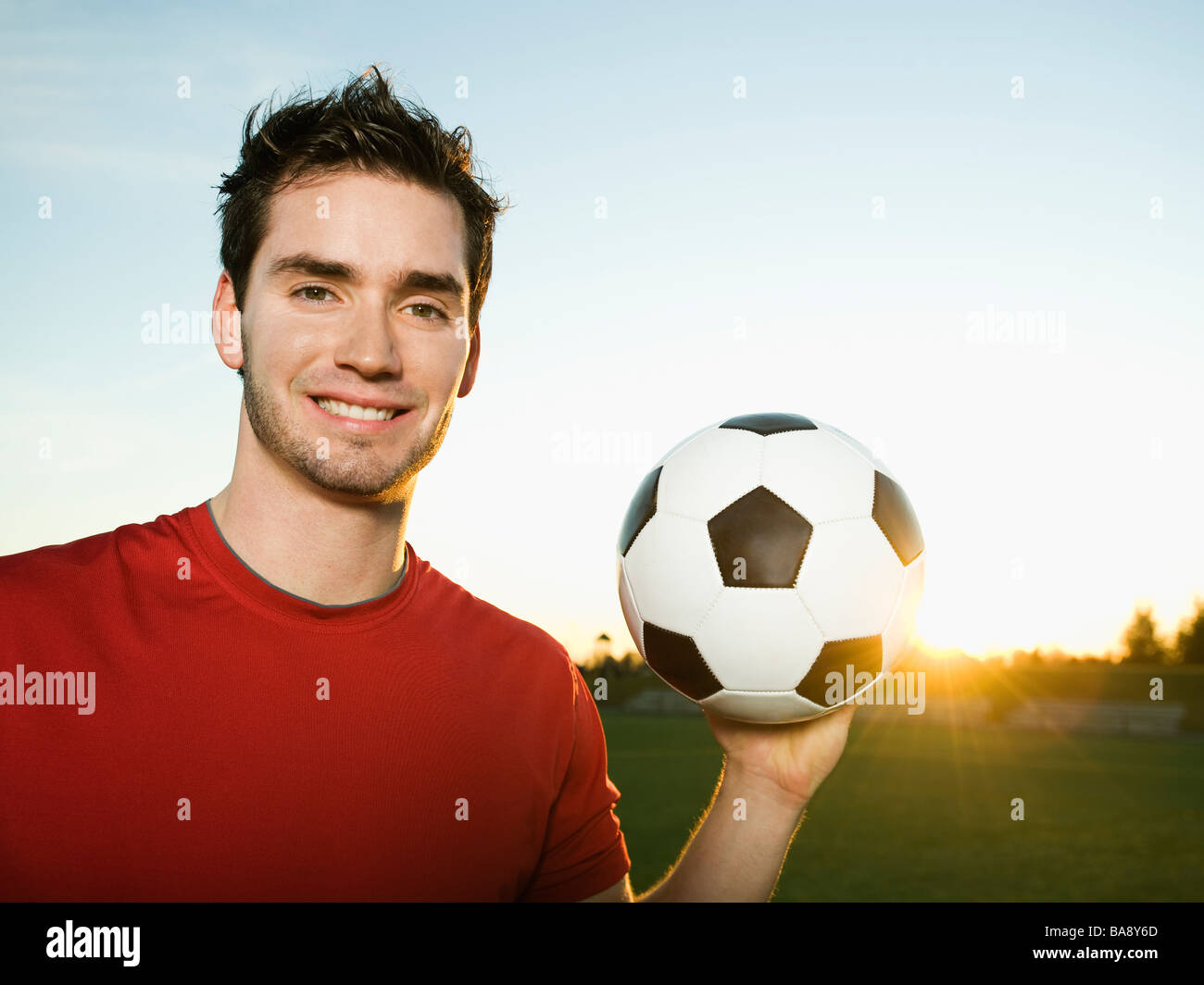 Soccer player holding ball Stock Photo Alamy