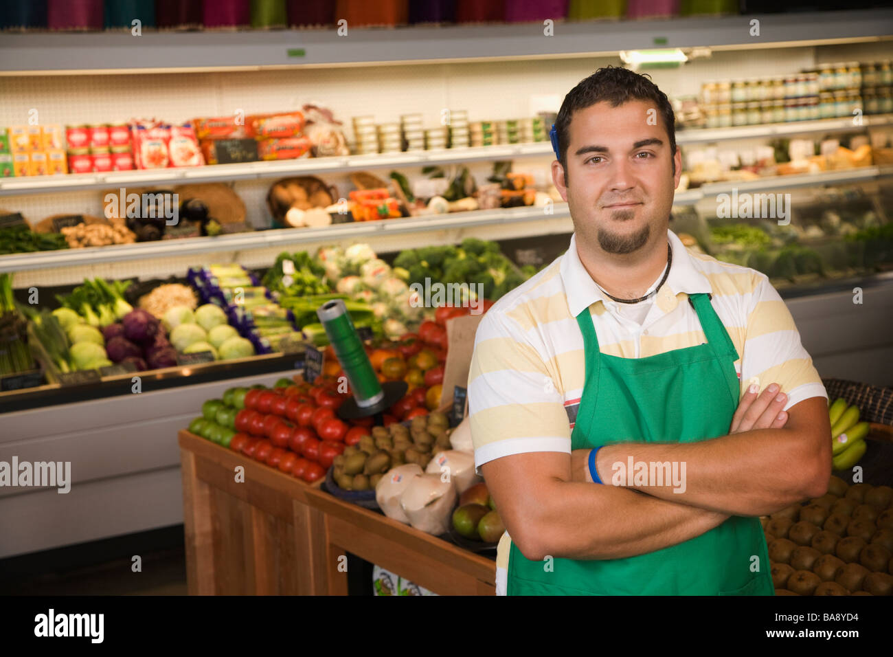 Worker posing in produce section Stock Photo Alamy