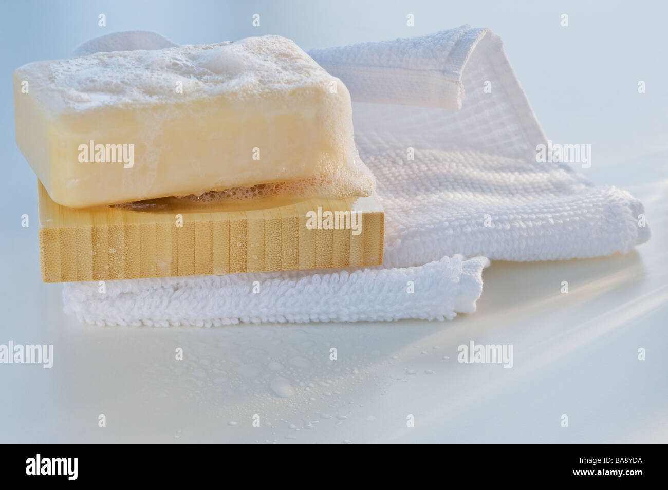 Towel and wet bar of soap Stock Photo Alamy
