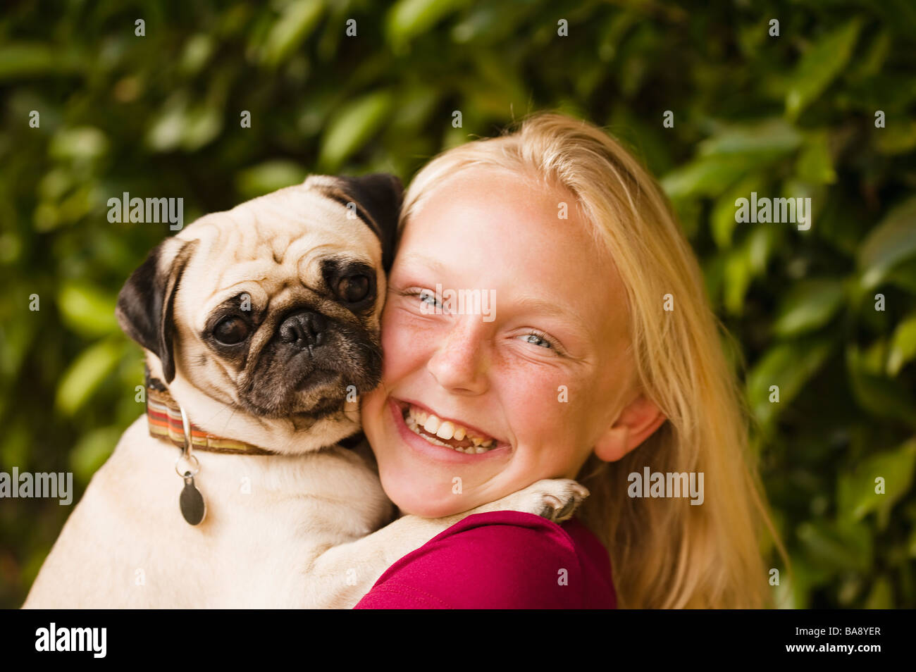 Girl holding dog Stock Photo