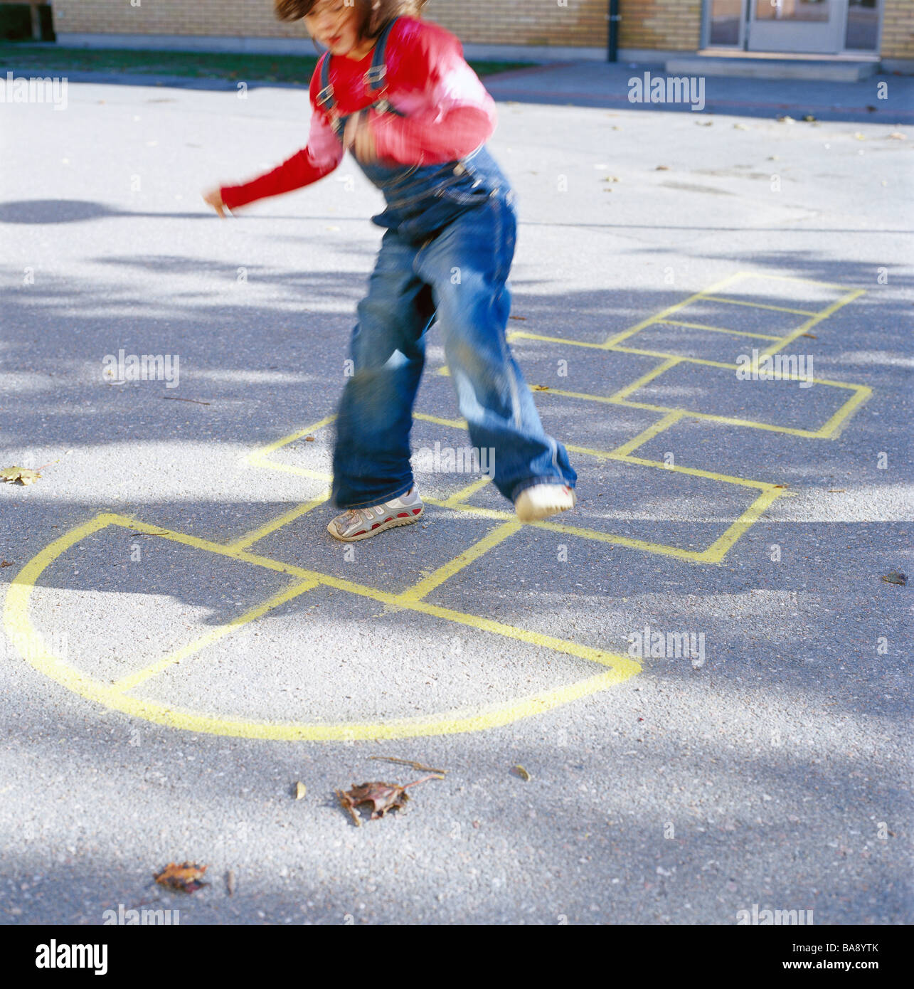 A girl playing hopscotch, Sweden. Stock Photo