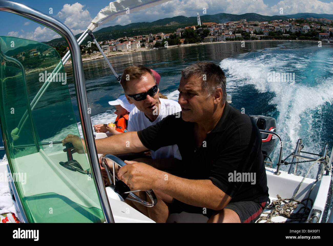 Two men in a motorboat Stock Photo - Alamy