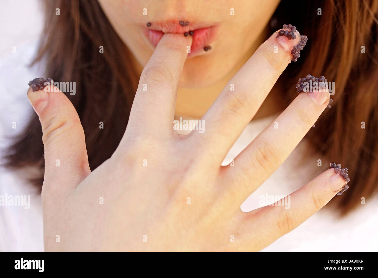 Eating caviar with fingers Stock Photo