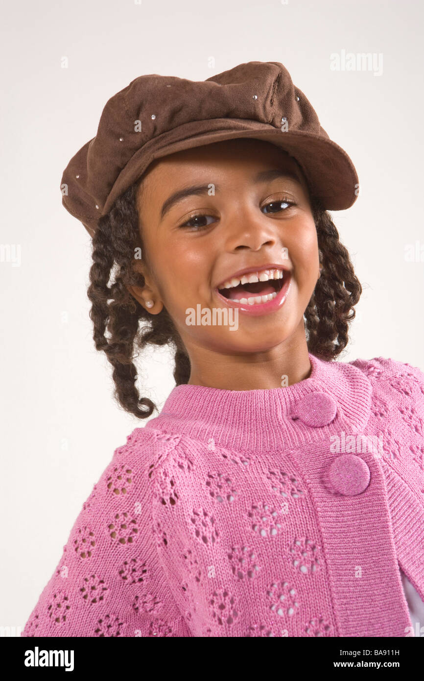 Portrait of young stylish African American girl in hat, studio shot Stock Photo