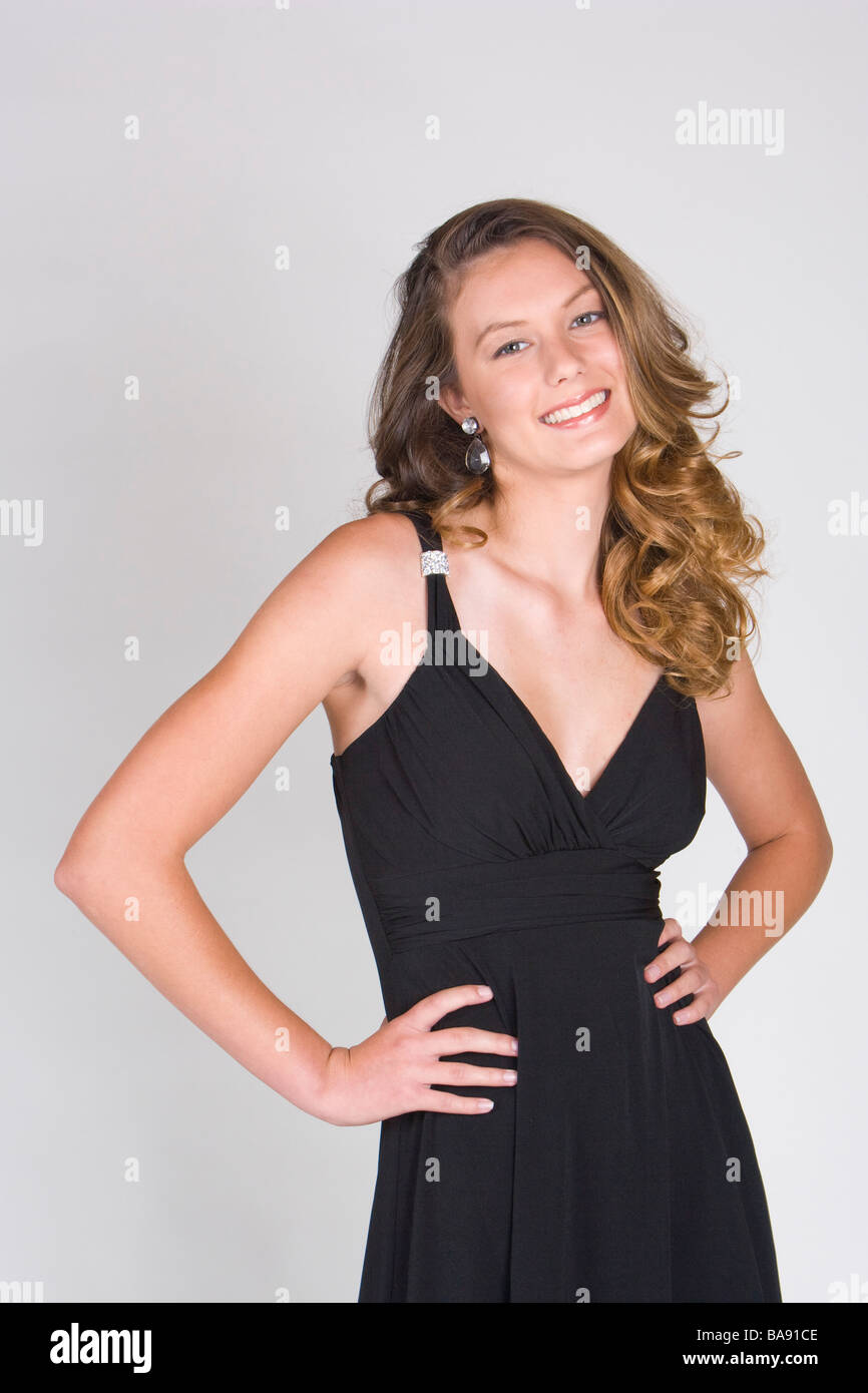 Portrait of young woman in black dress, studio shot Stock Photo - Alamy