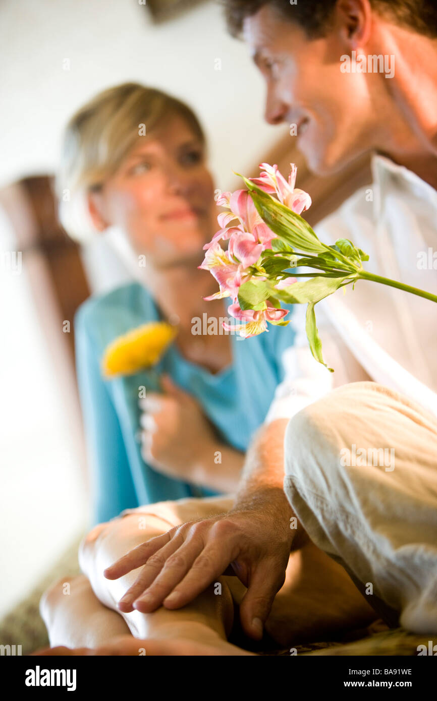 Couple sitting on bed flowers hi-res stock photography and images - Alamy