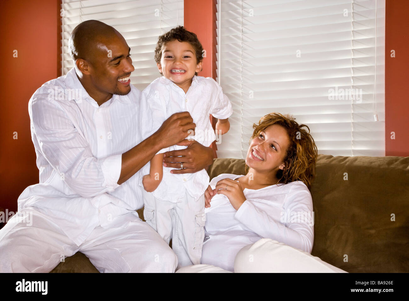 Portrait of happy African American family in living room Stock Photo Alamy