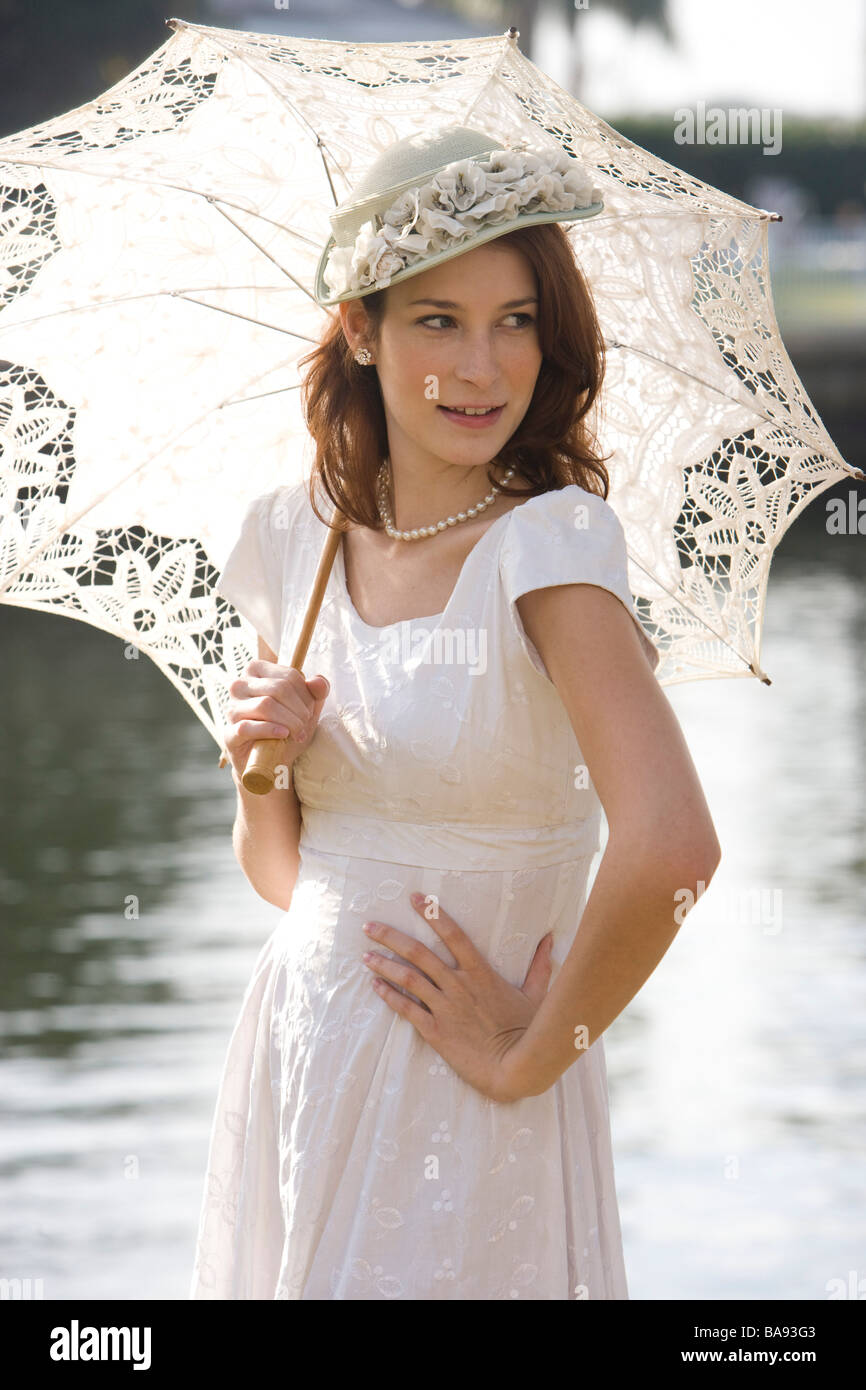Elegant lady in white dress holding parasol Stock Photo - Alamy