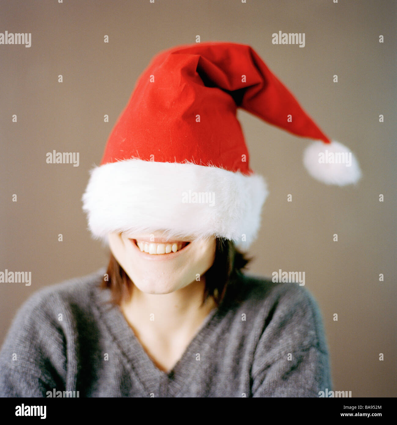 Portrait of a woman wearing a too big Father Christmas cap, Sweden. Stock Photo