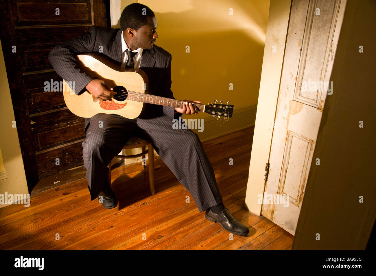 African american man playing a guitar hi-res stock photography and ...