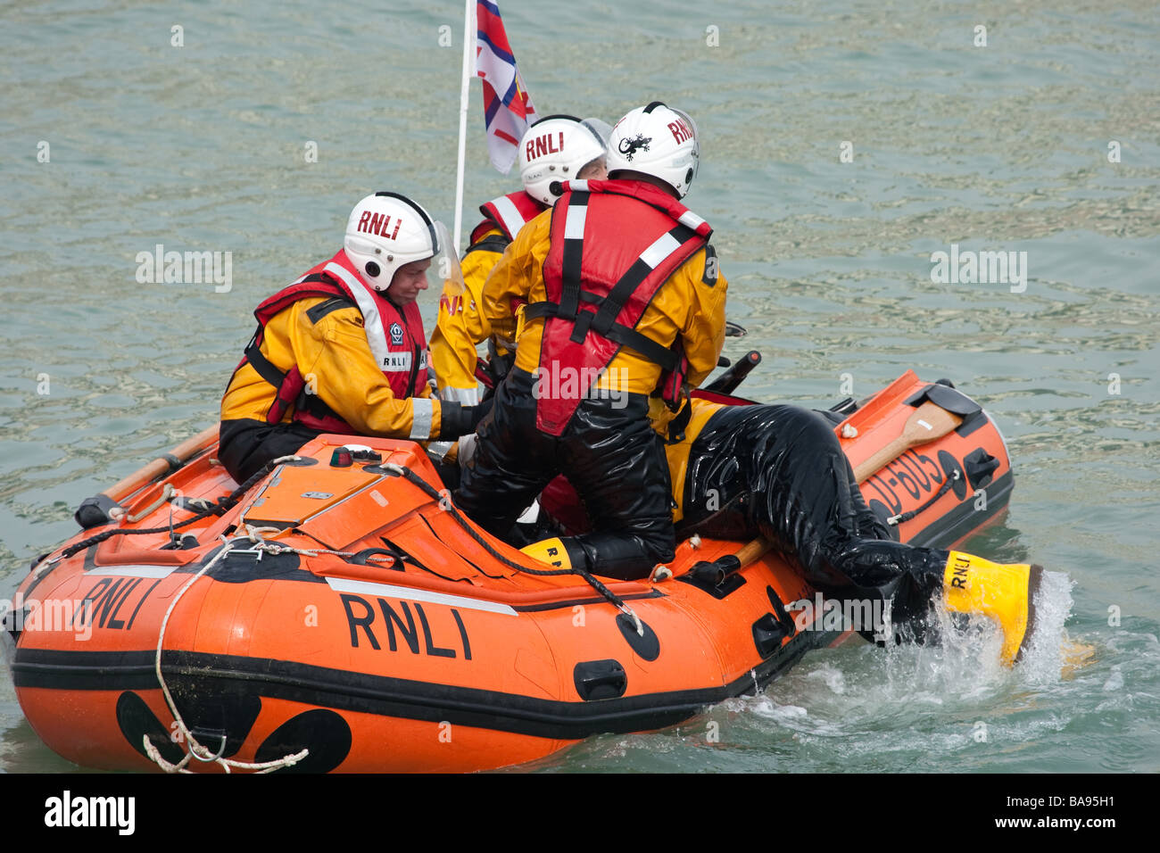 RNLI (Royal National Lifeboat Institution) crew members in a boat during a training exercise. Stock Photo