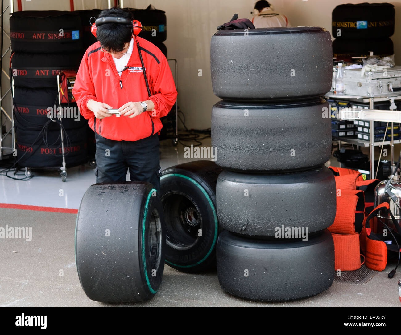 Bridgestone technician photographs a worn slick racing tire during Formula One testing sessions in March 2009 Stock Photo