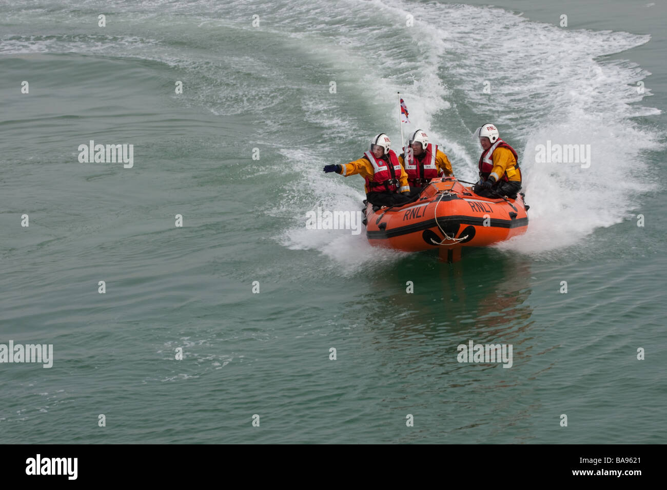 RNLI (Royal National Lifeboat Institution) crew members in a boat during a training exercise. Stock Photo
