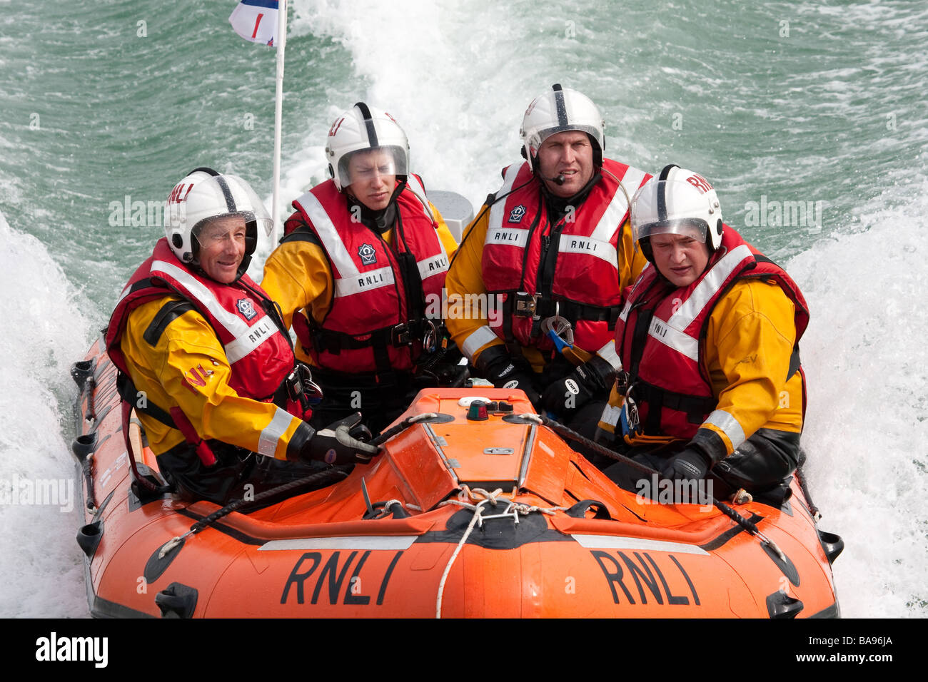 RNLI (Royal National Lifeboat Institution) crew members in a boat during a training exercise. Stock Photo