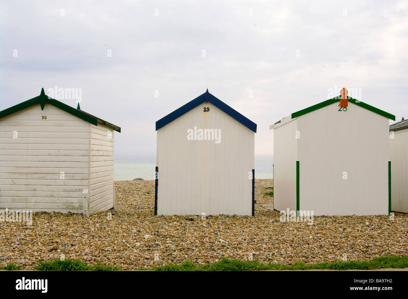 Seafront Wooden Beach Huts On The Seashore On a Cloudy Day Goring By