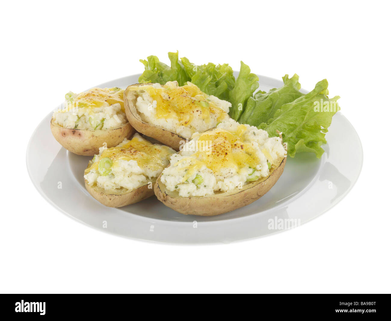 Freshly Baked Jacket Potatoes Topped With Melted Cheese And A Salad Garnish Isolated Against A White Background With No People And A Clipping Path Stock Photo