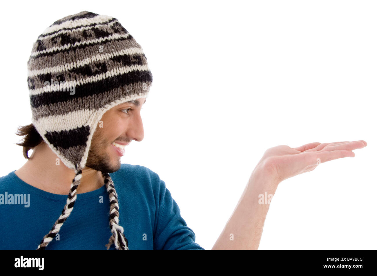 handsome guy wearing woolen cap with open palm Stock Photo - Alamy