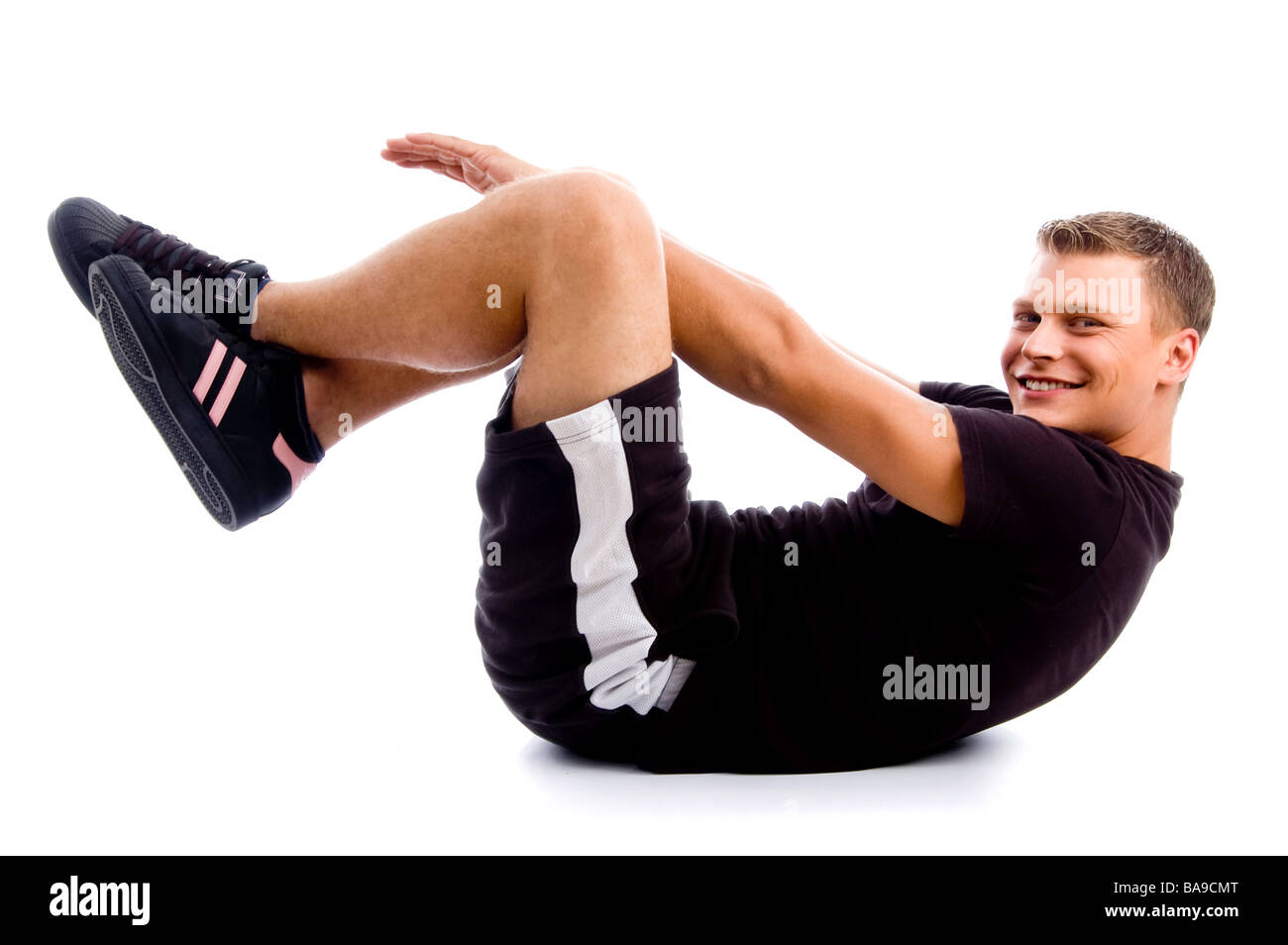 handsome muscular guy doing crunches Stock Photo