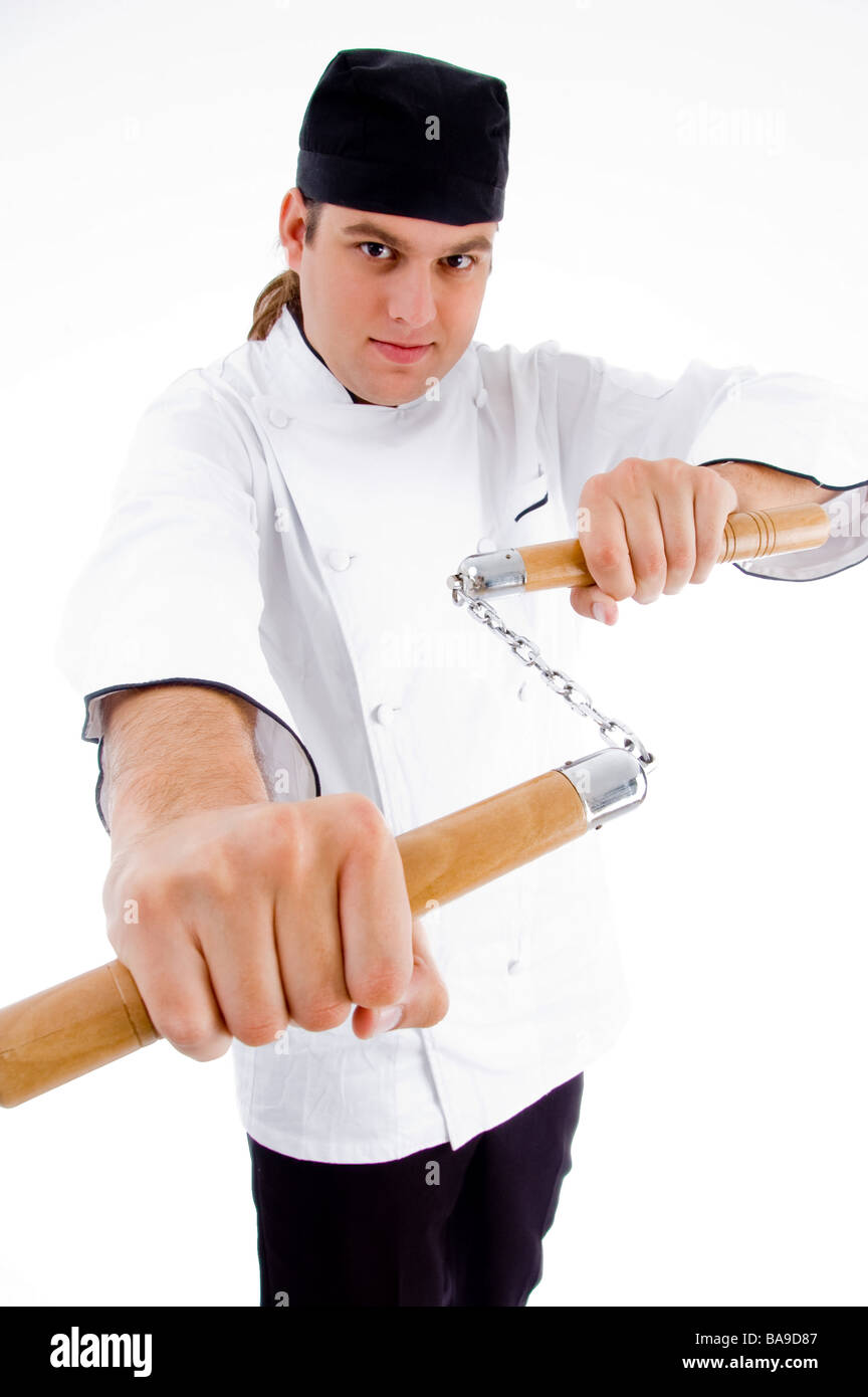 chef holding nunchaku in fighting stance Stock Photo Alamy