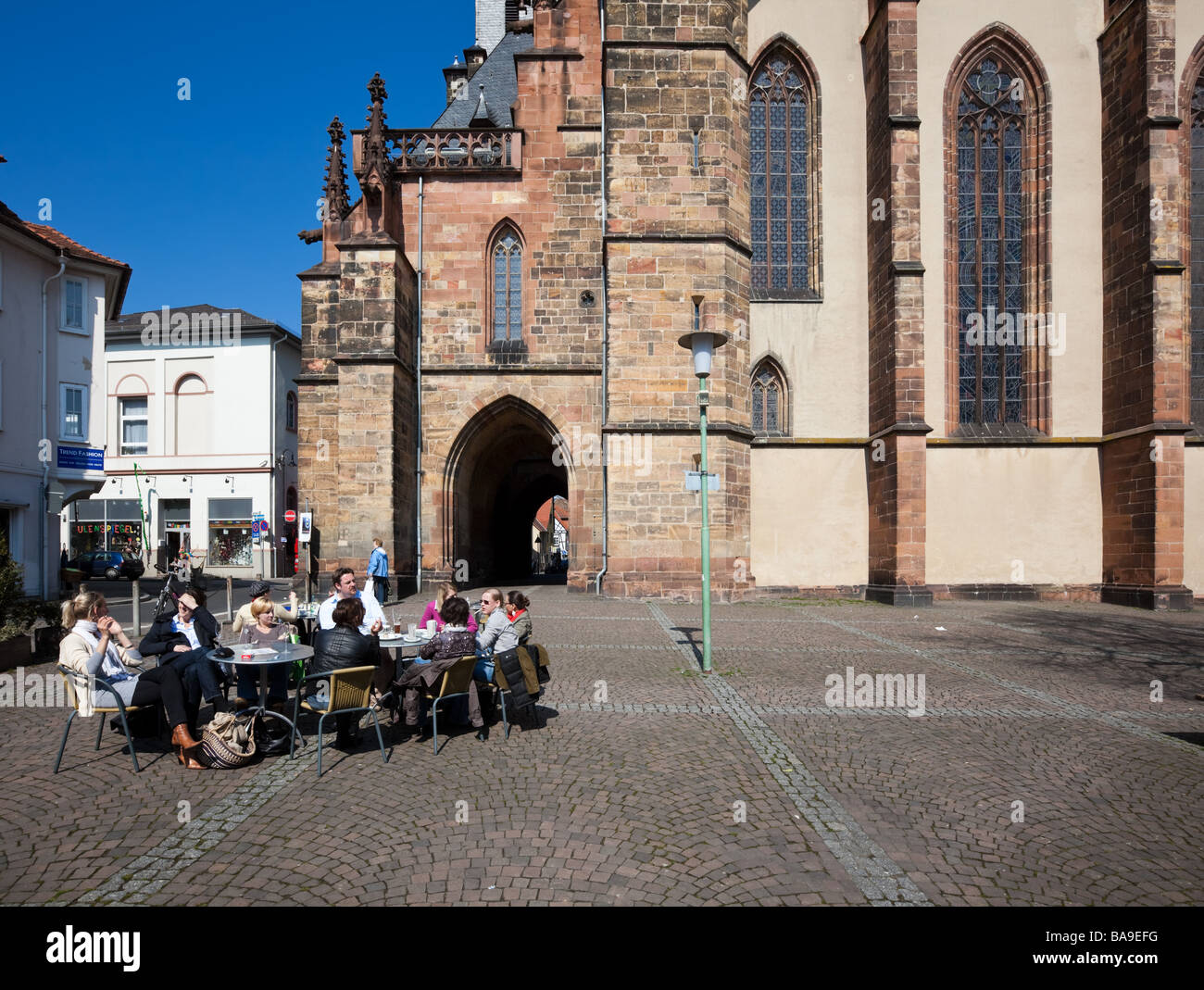 A cafe in front of the Stadtkirche in Friedberg which dates from 1260 Stock Photo