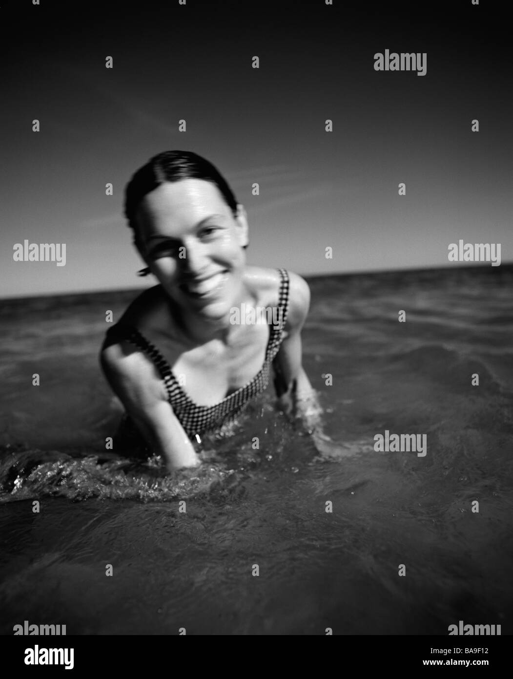 A smiling woman bathing in the sea, Sweden. Stock Photo