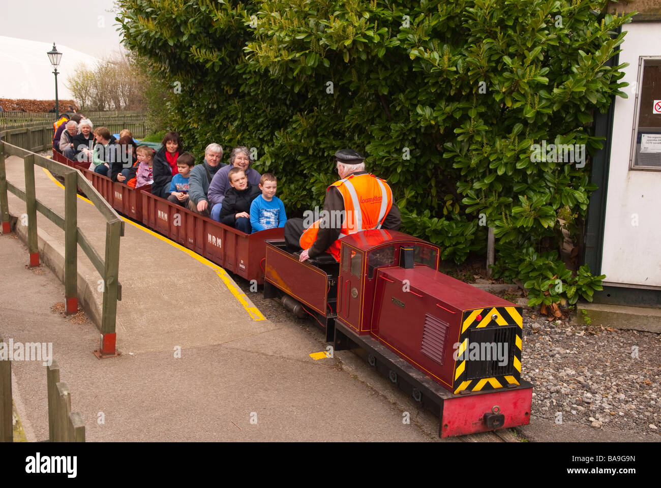 Visitors riding on the miniature railway train at the railway museum in