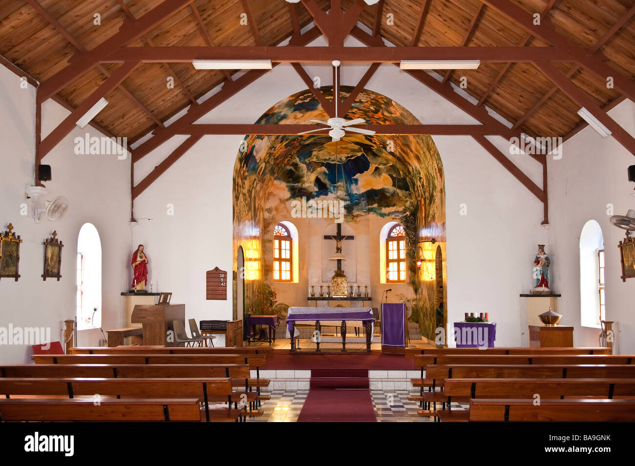 Interior view of Sacred Heart Roman Catholic Church in The Bottom, Saba with painted mural by Heleen Comet in the apse Stock Photo
