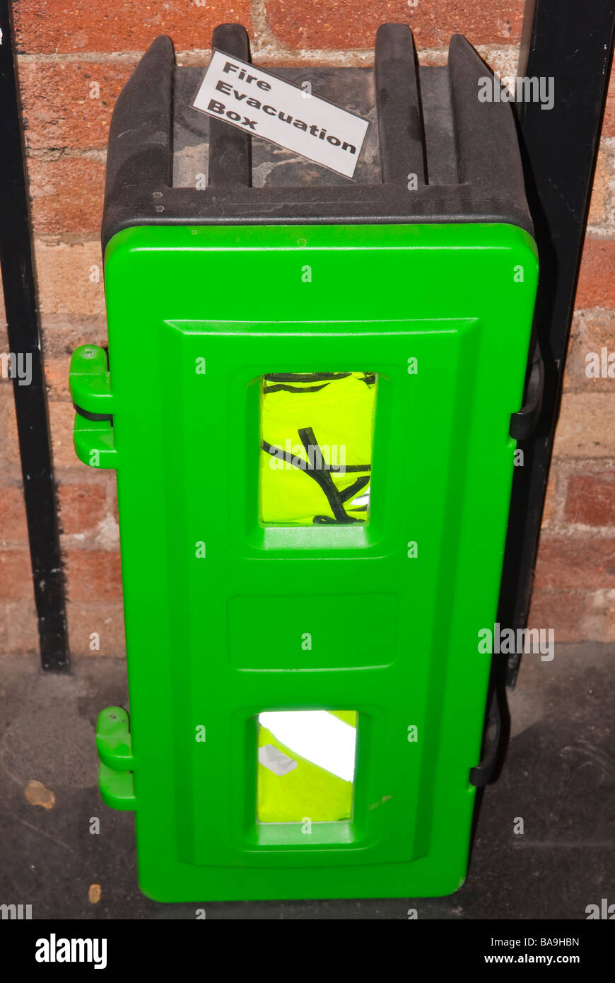 A green fire evacuation box for health & safety fixed to a wall Stock Photo
