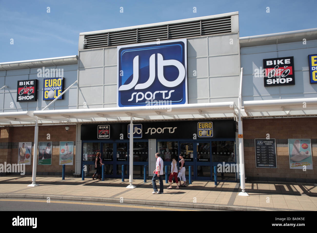 Shoppers going past JJB Sports store, Robin Retail Park, Wigan Stock