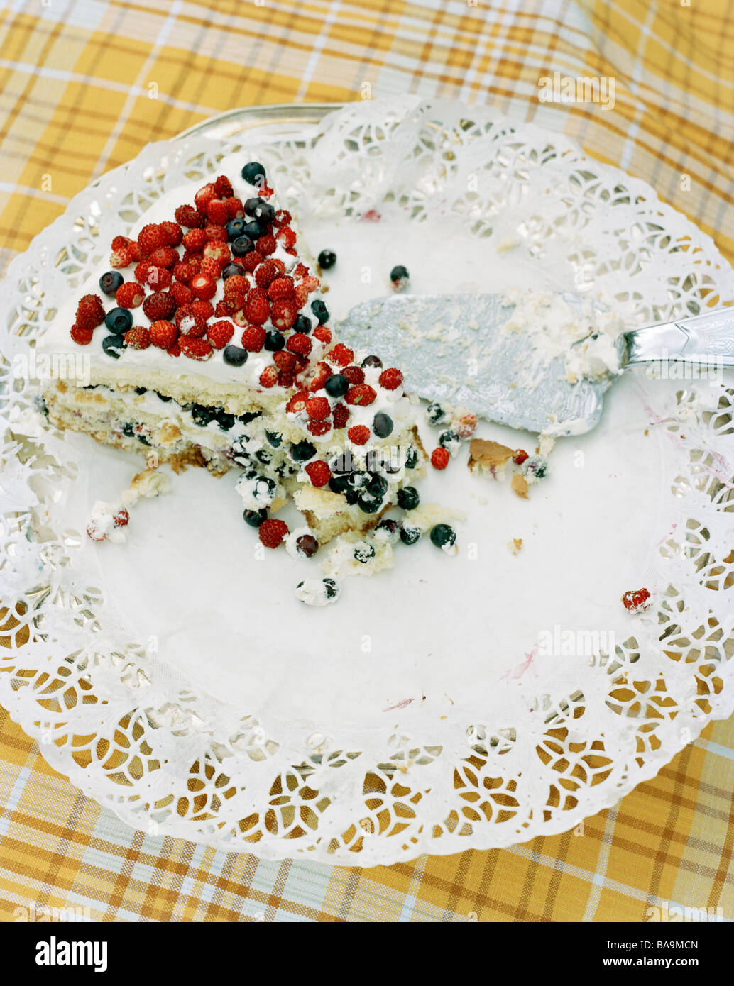 A cake garnished with wild strawberries and bilberries, Sweden. Stock Photo