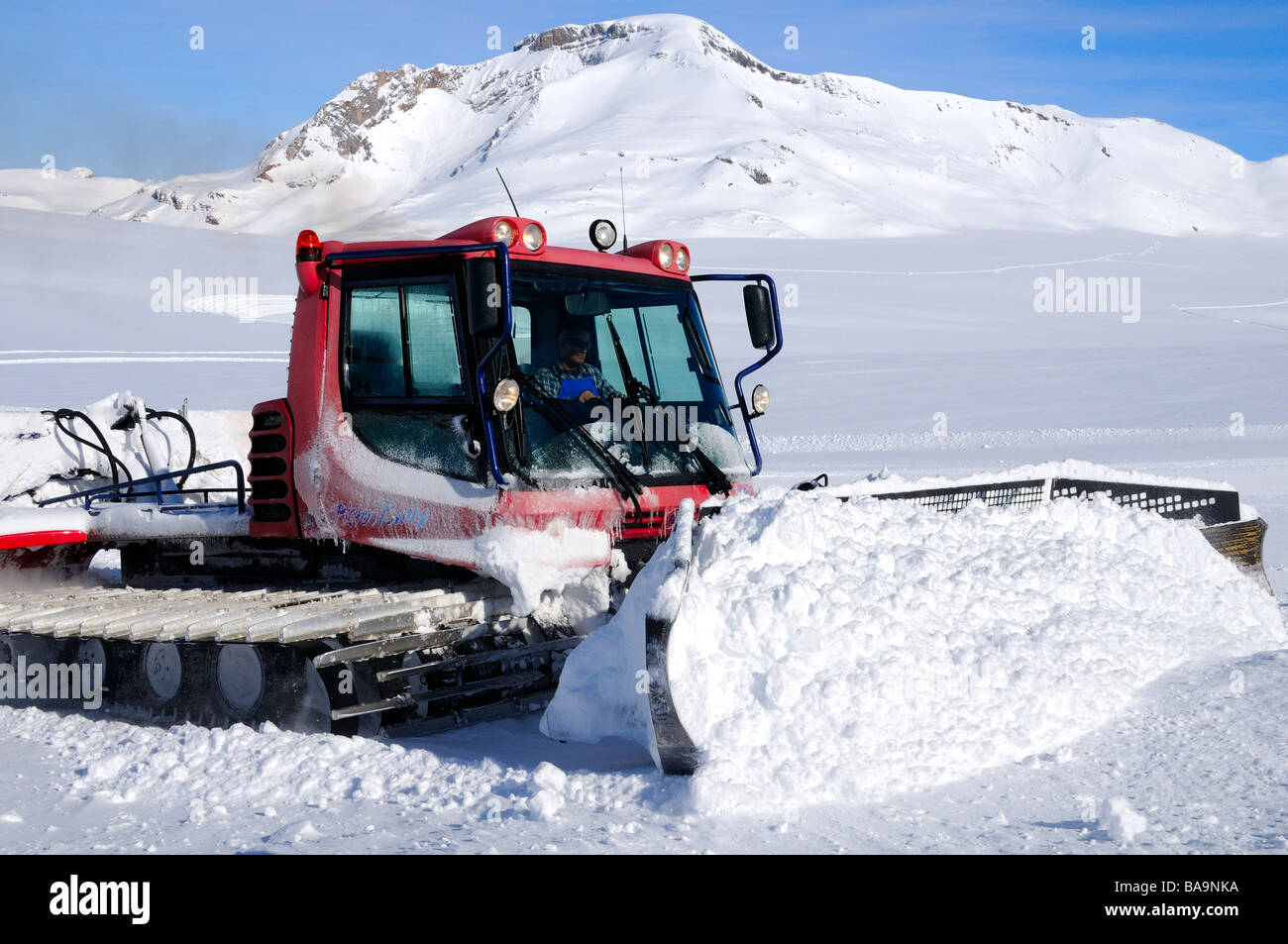 PistenBully Kässbohrer snow processing machine in action on the Plaine Morte Glacier Crans Montana Switzerland Stock Photo