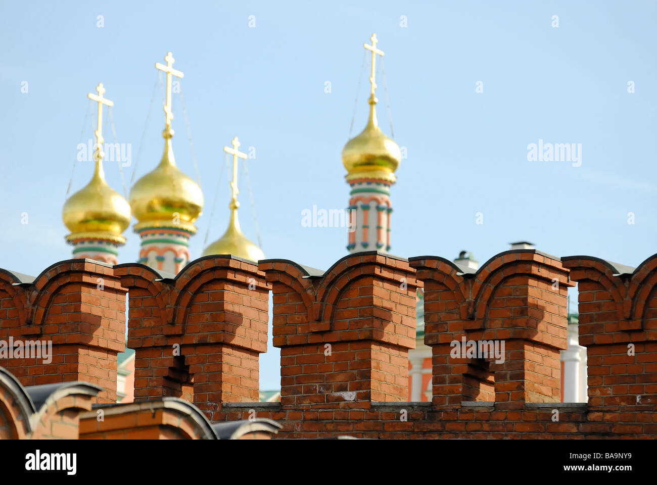 Golden domes of Russian church behind a Kremlin wall Moscow Russia Stock Photo