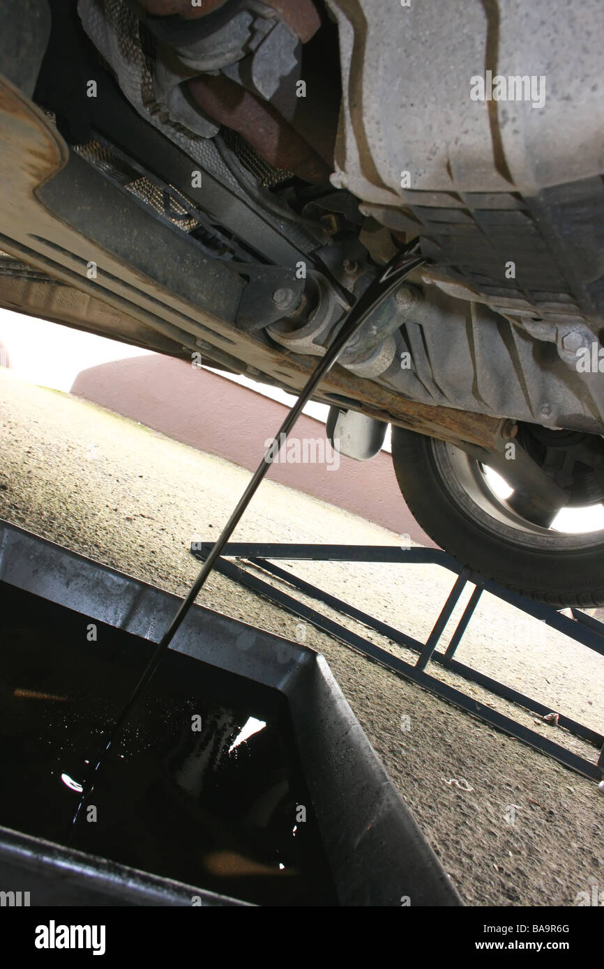 Draining oil during a car service Stock Photo Alamy