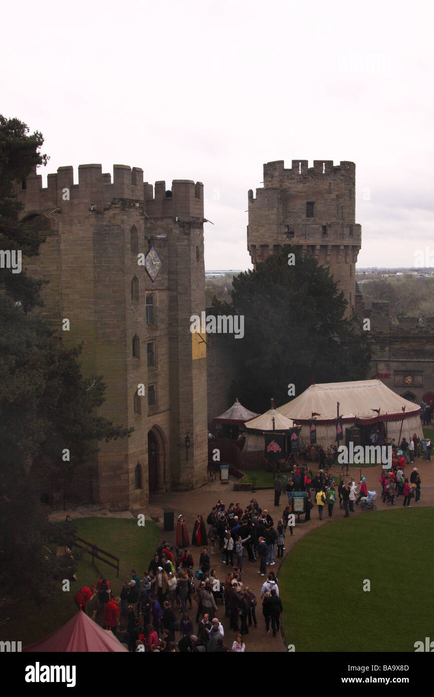 the battlements of warwick castle looking towards the tower containing the main entrance and portcullis Stock Photo