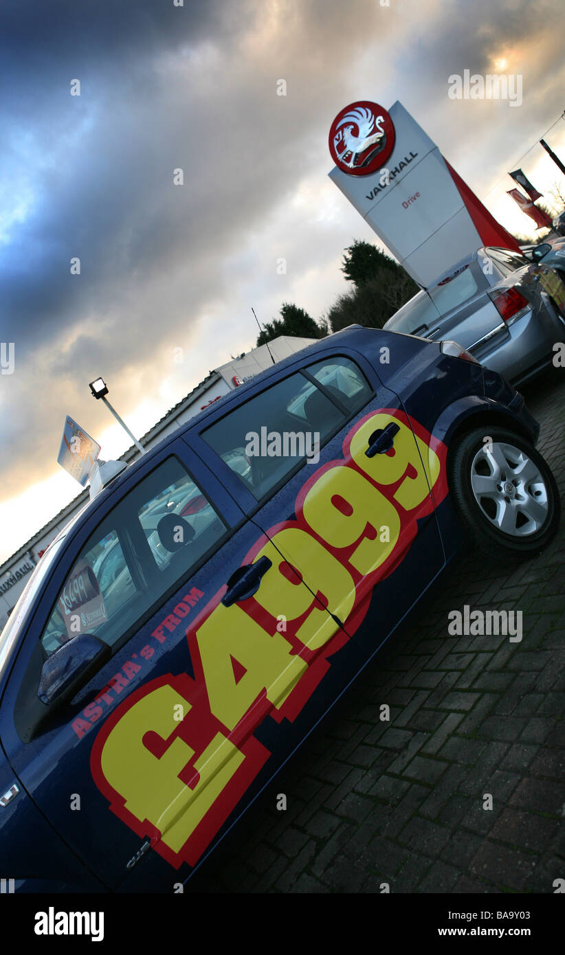 New and Used Vauxhall Cars for sale sit outside on a dealer forecourt