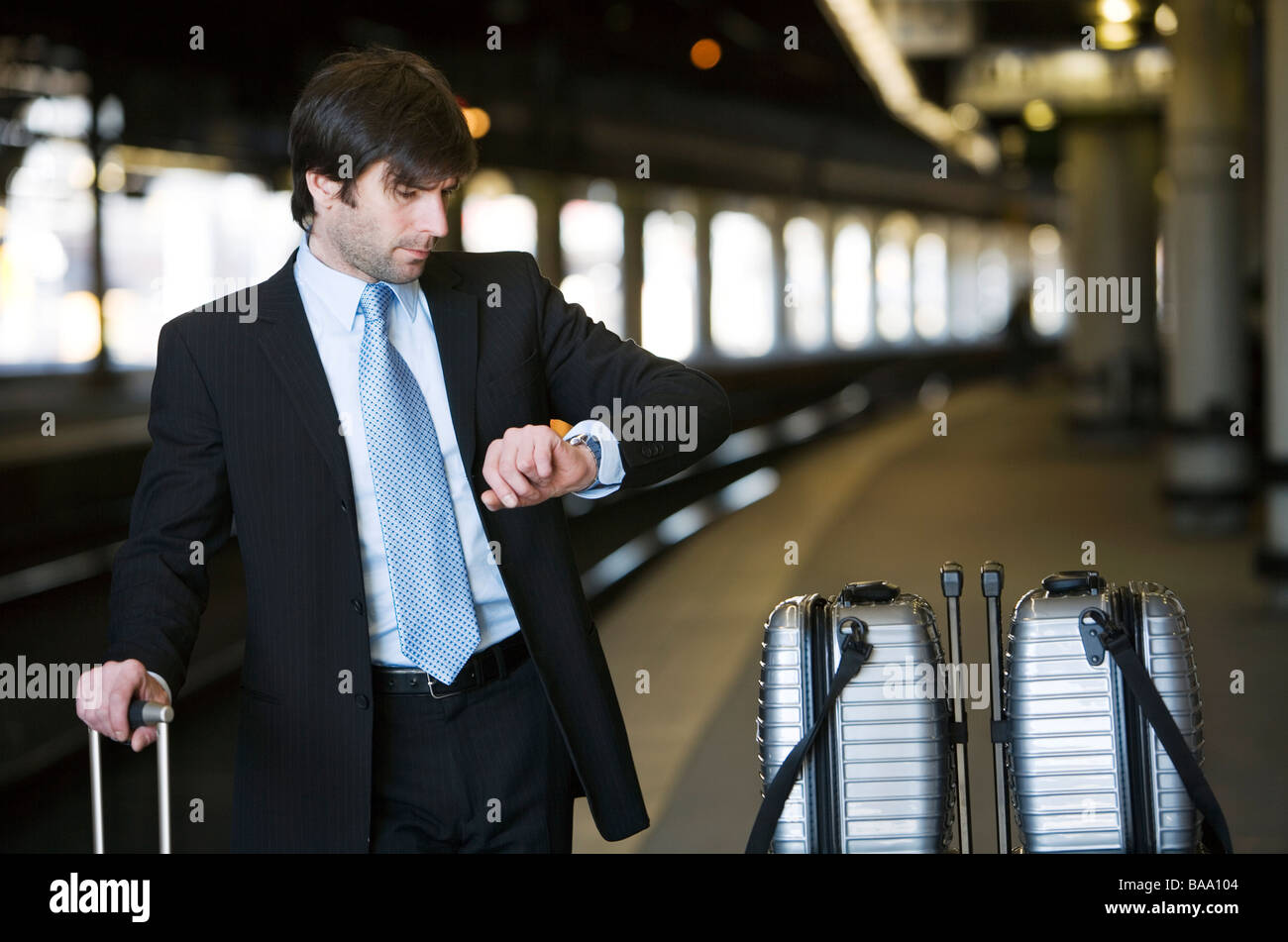 Businessman with suitcases standing at the trainstation waiting, Stockholm, Sweden. Stock Photo