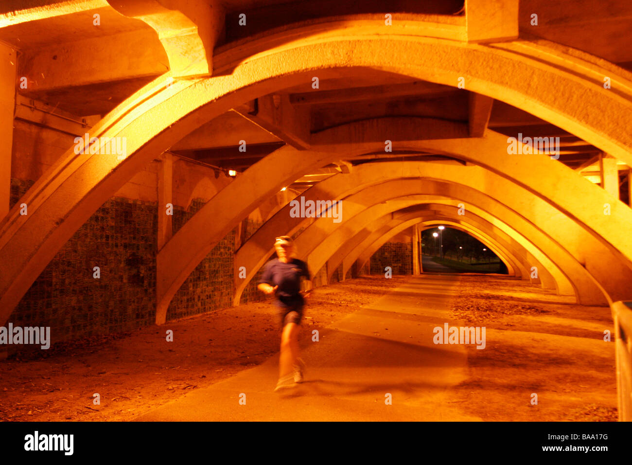 A runner runs under the King William Street Bridge in Adelaide next to