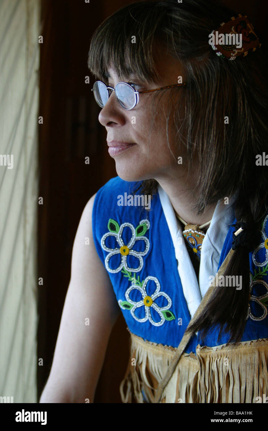 A First Nations female wears tradtional caribou leather clothing in the community of Old Crow, Yukon Territory, Canada. Stock Photo