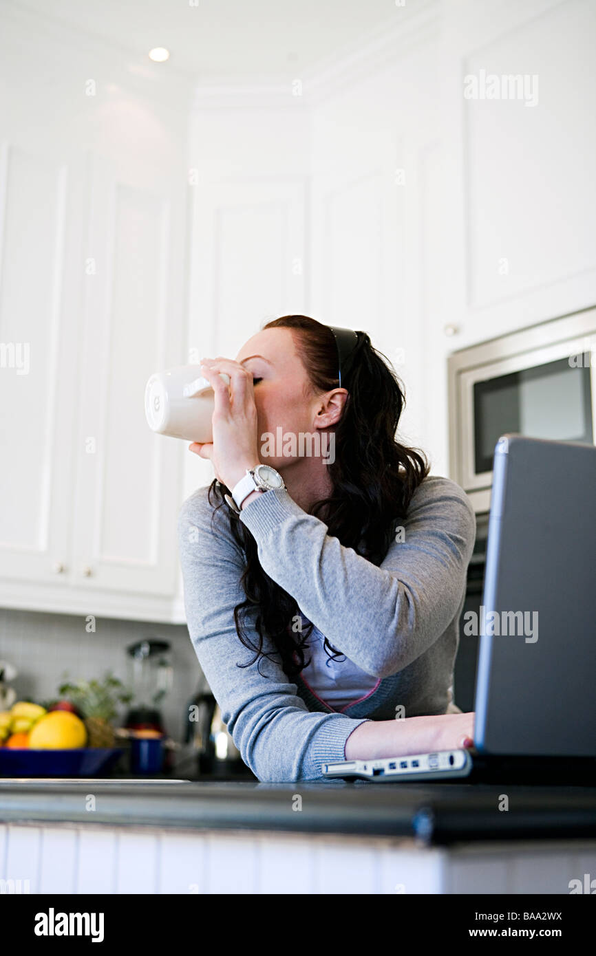 A woman in front of a laptop at home, Sweden. Stock Photo