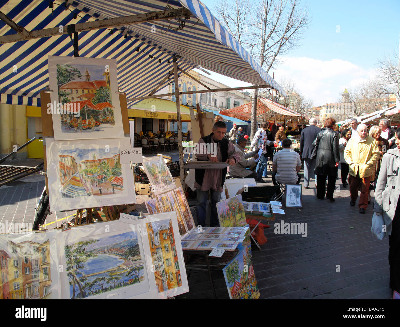 Artist selling paintings at market in Nice, France Stock Photo