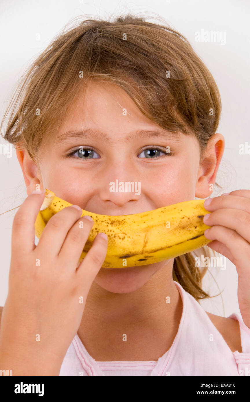 little girl eating banana Stock Photo Alamy