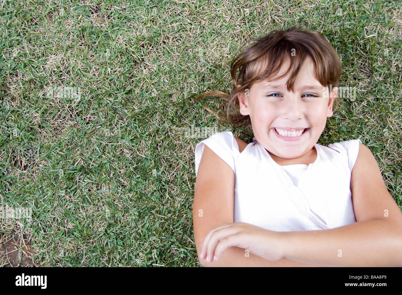 young cute girl lying on the grass Stock Photo - Alamy