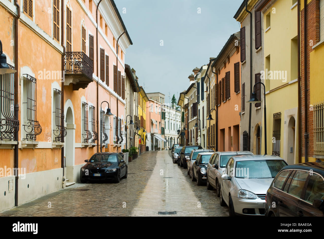 photograph of colourful italian street in ravenna with parked cars