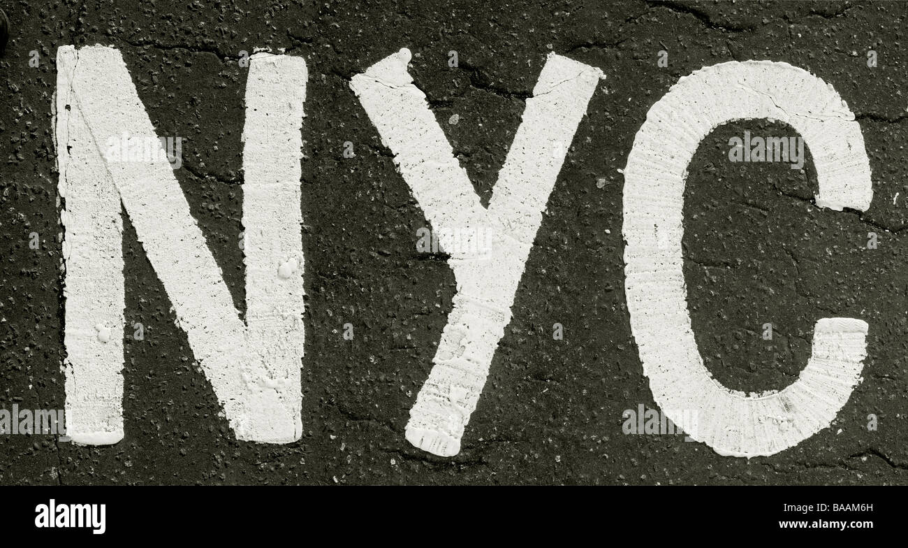 Painted capital letters NYC on asphalt Stock Photo