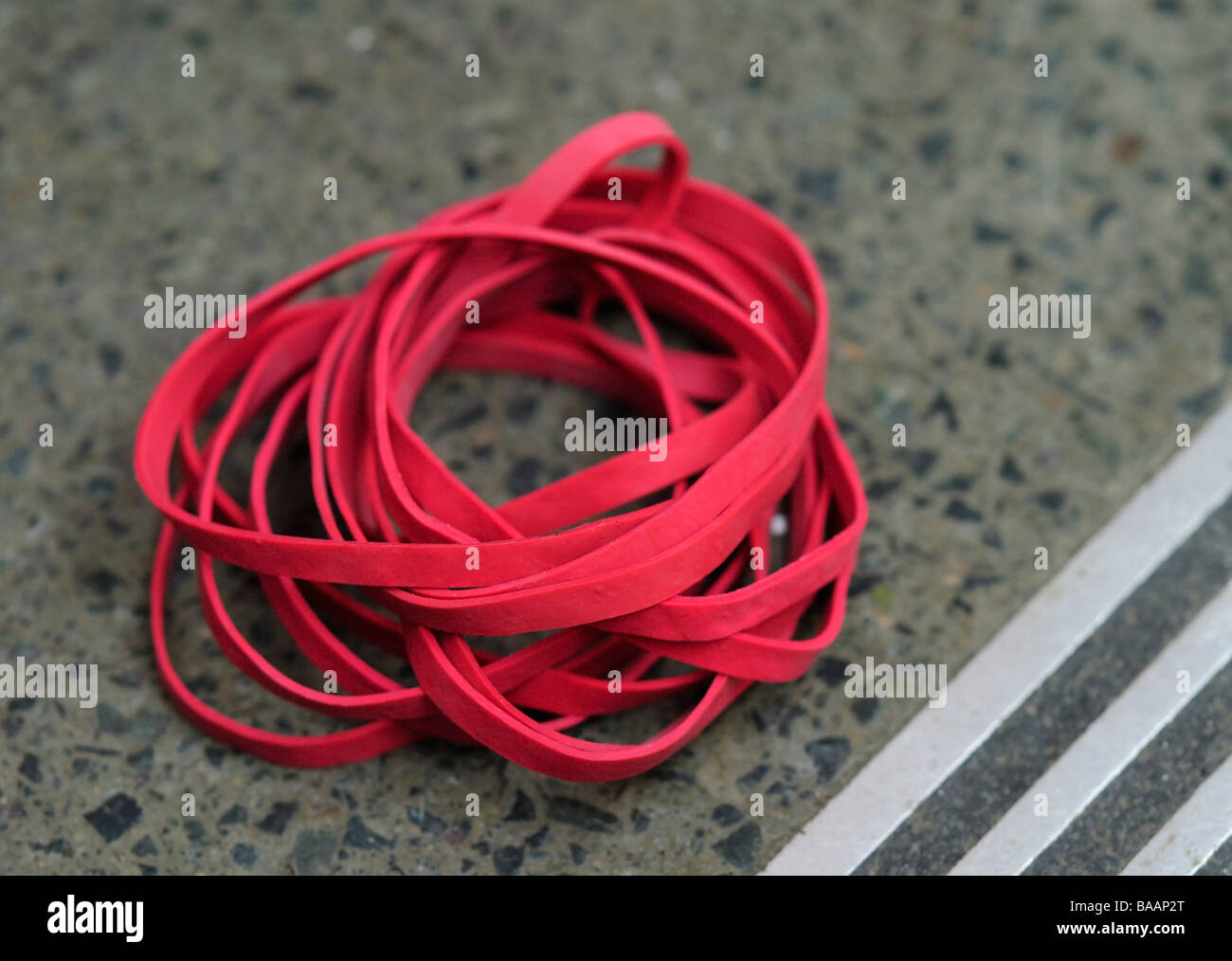 Discarded Red Post Office Elastic Bands Stock Photo - Alamy